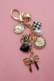 BOW CHECKER HEART FLOWER BAG CHARM | 80K049: Gold